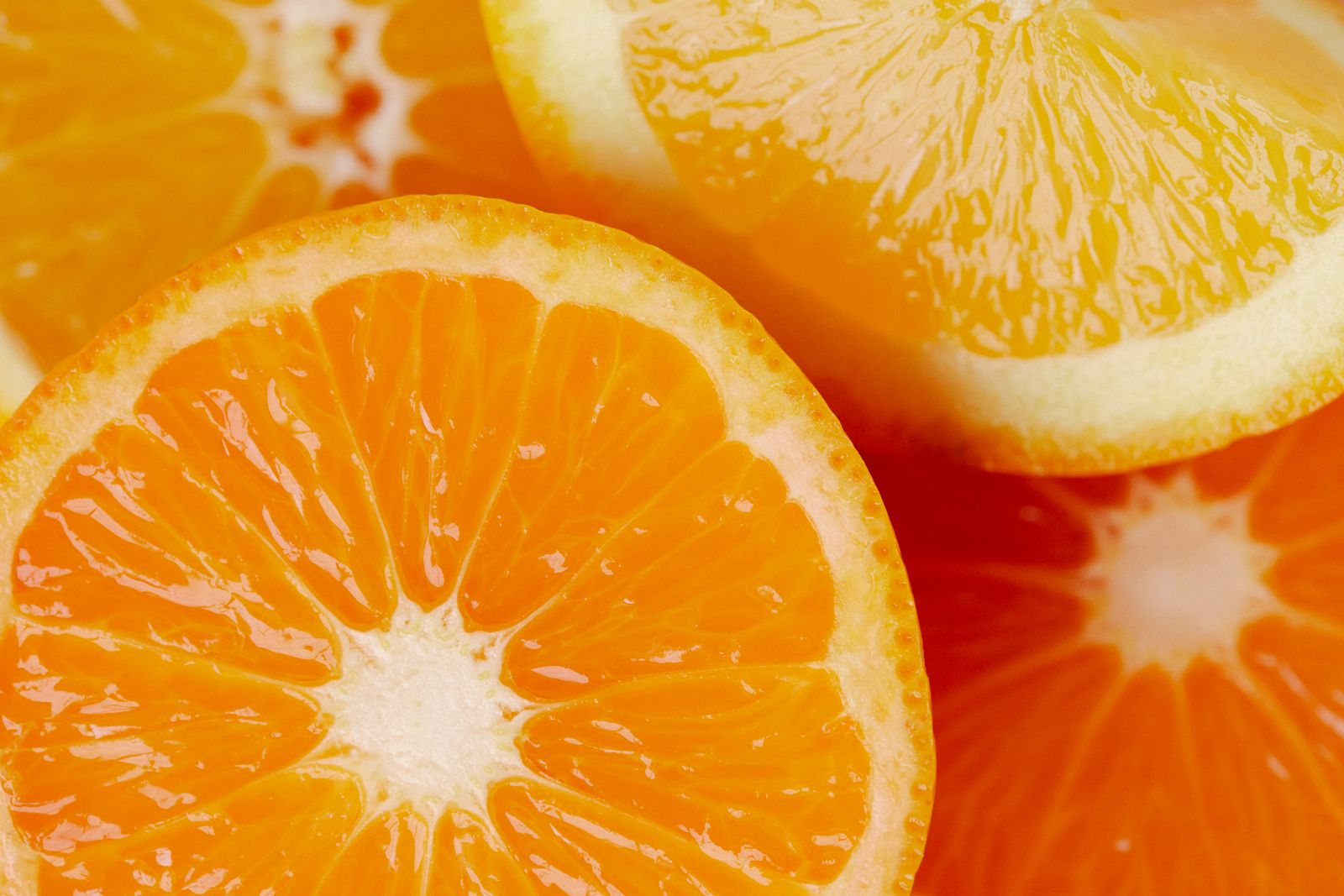 Glossy orange citrus slices photographed in extreme close-up